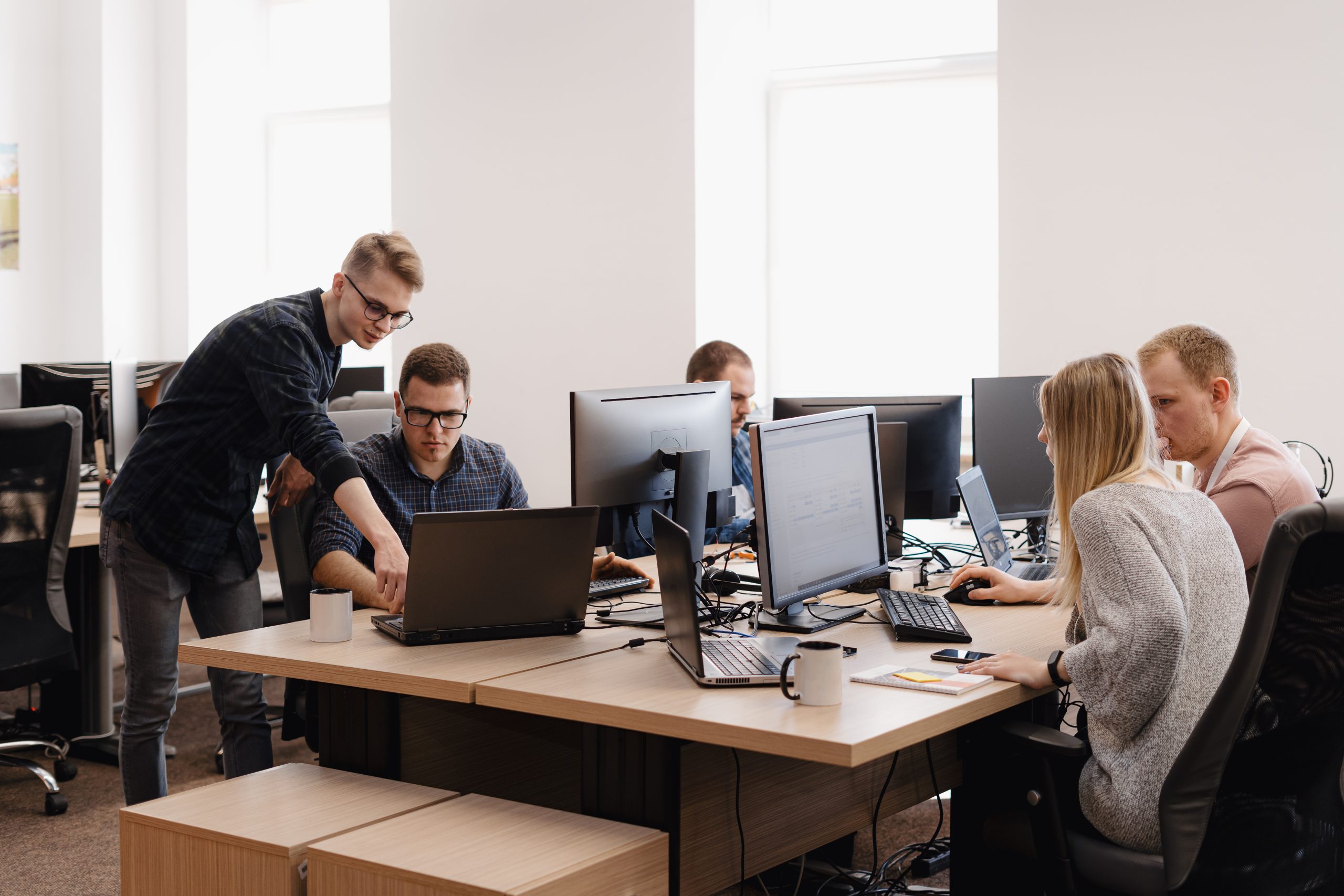 A professional, modern, and brightly lit corporate workspace in Cleveland where Direct Connect technology professionals manage infrastructure tools and active cybersecurity databases on digital dashboards